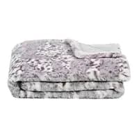 Gefaltete graue und weiße Decke mit Leopardenmuster auf einer Seite und einfarbig weißer Rückseite