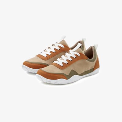 Zwei beige und braune Sneakers mit weißer Sohle und weißen Schnürsenkeln, seitlich und leicht versetzt nebeneinander fotografiert
